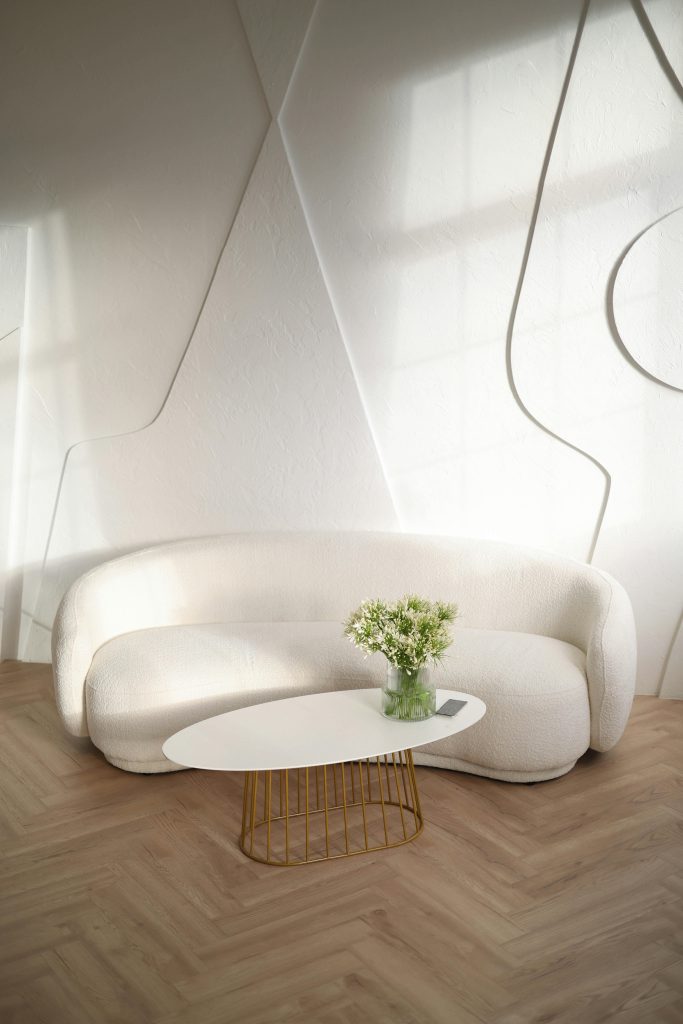pexels-photo-18920421-18920421 Elegant living room with a sleek white sofa, stylish table, and soft lighting.